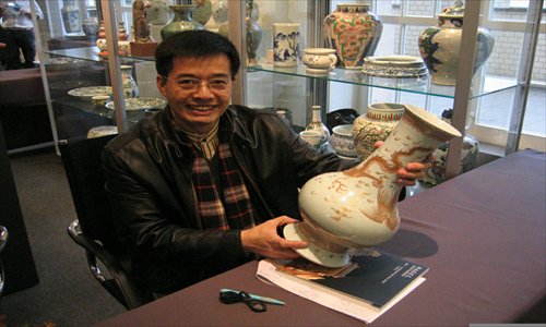 An Antiques Dealers Quest Cheng Yong appreciates a Chinese antique at the Nagel Auction House in Stuttgart, Germany.Photo: Courtesy of Cheng Yong