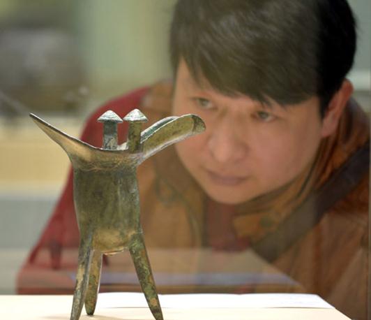 Art spending in China slows in 2014 as collectors seek masterworks at home and abroad. bronze-jue