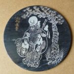 Unusual & stylish circular Chinese black marble plaque engraved with an Immortal Unusual & stylish circular Chinese black marble plaque engraved with an Immortal