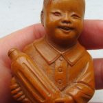 Vintage antique hand carved oriental nut or wood miniature figure of a boy Vintage antique hand carved oriental nut or wood miniature figure of a boy