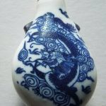A CHINESE BLUE DRAGON PORCELAIN SNUFF BOTTLE WITH STOPPER WITH SPOON. A CHINESE BLUE DRAGON PORCELAIN SNUFF BOTTLE WITH STOPPER WITH SPOON.