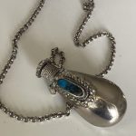 vintage decorative white metal snuff bottle on long chain vintage decorative white metal snuff bottle on long chain