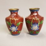 Pair of Chinese cloisonne vases decorated with lotus on read background. Pair of Chinese cloisonne vases decorated with lotus on read background.