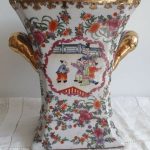 A JUWC FLUTED SQUARE FORM VASE DECORATED IN GILT WITH ORIENTAL FAMILY SCENE.... A JUWC FLUTED SQUARE FORM VASE DECORATED IN GILT WITH ORIENTAL FAMILY SCENE....