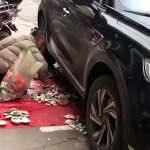 Vendor demands fair compensation for antique porcelain tiles crushed by passing car at Jingdezhen market car